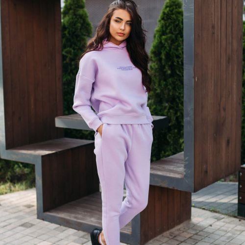 picture-pretty-caucasian-female-purple-sport-suit-black-trainers-keeps-her-hands-pockets